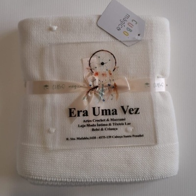 Manta branca com etiqueta de loja artesanal