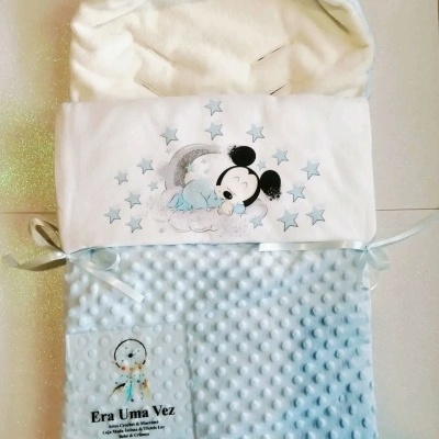 saco de dormir para bebé azul claro com interior branco felpudo e estampa de Mickey a dormir entre estrelas