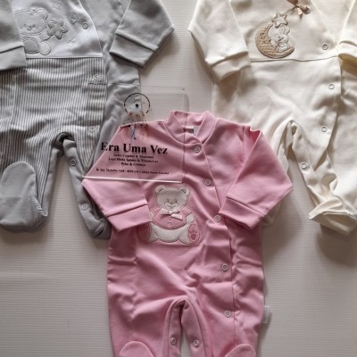 Três macacões de bebé em cinza, branco e rosa com bordados, botões frontais, e placa de acrílico com texto Era Uma Vez.