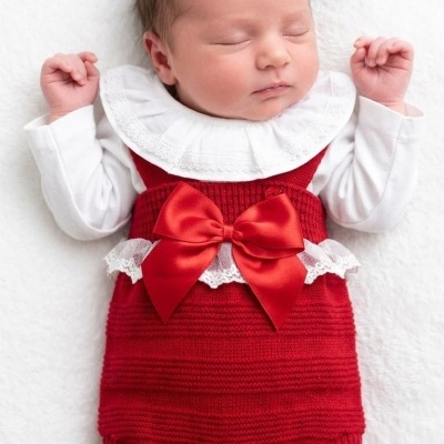 Bebé a dormir com roupa vermelha e branca
