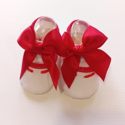 Sapatinhos brancos de bebé com laços vermelhos