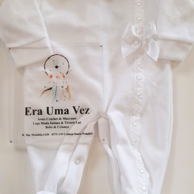 Pijama branco para bebé com gola pregueada e laço decorativo.