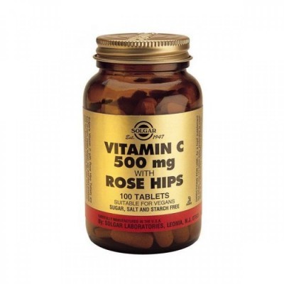 Frasco de vidro castanho com comprimidos e rótulo dourado de vitamina C