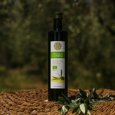 Garrafa de azeite Azeites do Cobral com ramo de oliveira em ambiente natural