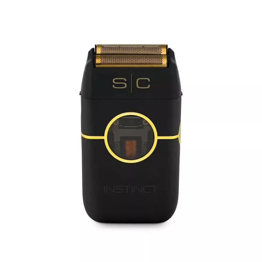 Aparelho de barbear elétrico preto com detalhes dourados, duas lâminas acima e janela circular frontal