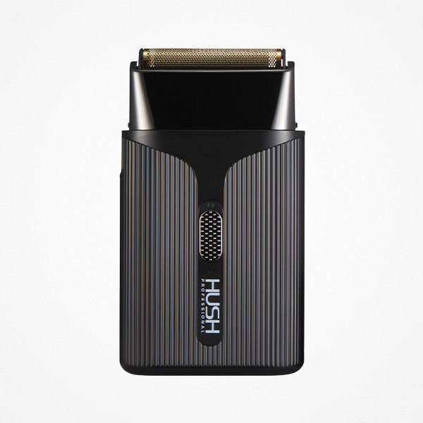 Máquina de barbear elétrica preta com detalhes dourados e texto HUSH PROFESSIONAL