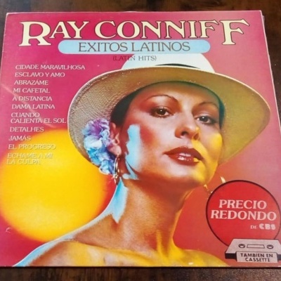 Capa de disco de Ray Conniff com mulher de chapéu branco e selo vermelho