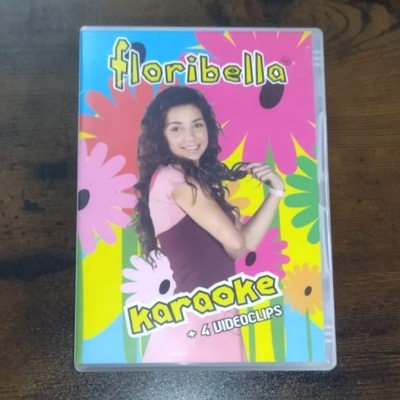 Caixa de DVD 'floribella karaoke + 4 VIDEOCLIPS' com capa colorida e jovem sorridente