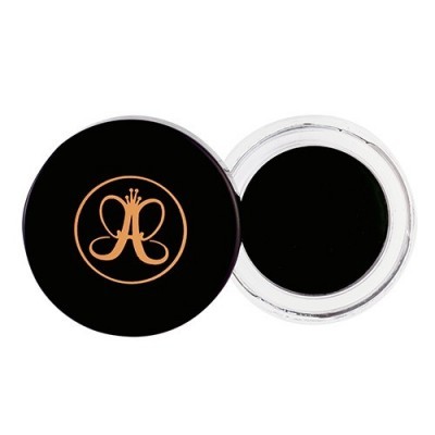 Pote de maquilhagem preto com tampa preta e logótipo dourado.