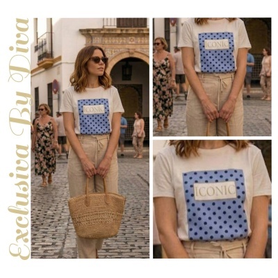 Mulher a usar t-shirt branca com estampa azul e texto ICONIC, calças bege e a segurar uma mala de palha