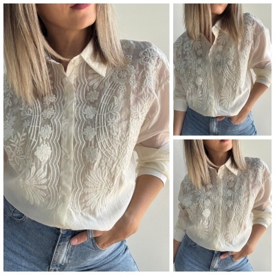 Blusa branca texturizada com padrão floral e calças de ganga azuis