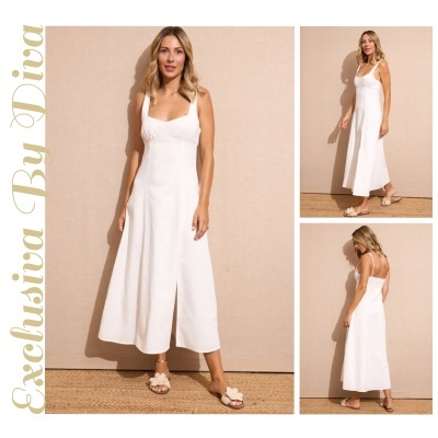 Vestido branco midi com alças largas e sandálias bege com flor ao lado de modelo diante de parede bege