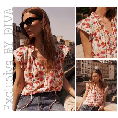 Blusa feminina floral com babados combinada com jeans e acessórios em ambiente urbano.
