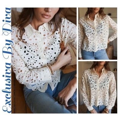 Blusa branca feminina bordada com padrão floral e botões, combinada com jeans azul claro.