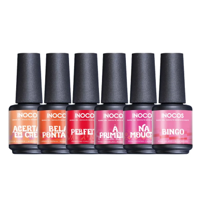 Seis vernizes INOCOS em frascos pretos com tampas pretas, em várias cores e etiquetas coloridas com nomes visíveis.