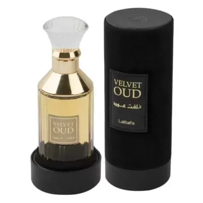 Frasco dourado de perfume Velvet Oud ao lado de embalagem cilindrica preta