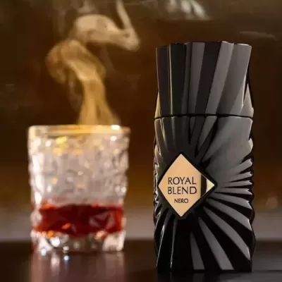 Frasco de perfume preto com design geométrico e copo de vidro com bebida quente