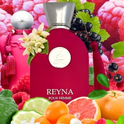 Frasco vermelho de perfume rodeado de frutas e flores