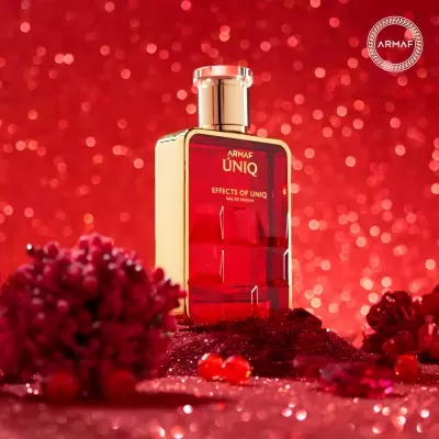Frasco de perfume vermelho 'ARMAF ÚNIQ Effects of Uniq' em fundo vermelho brilhante.