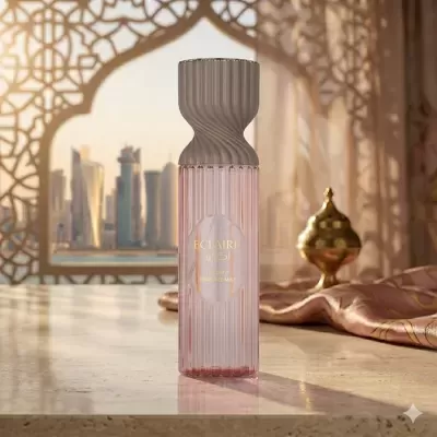 Frasco rosa de perfume ECLAIRE com tampa cinzenta numa superfície de pedra e fundo arquitetônico árabe