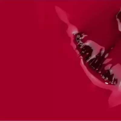 textura líquida vermelha com objeto claro e escuro irregular