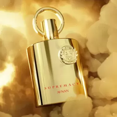 Frasco dourado de perfume SUPREMACY AFNAN com emblema circular