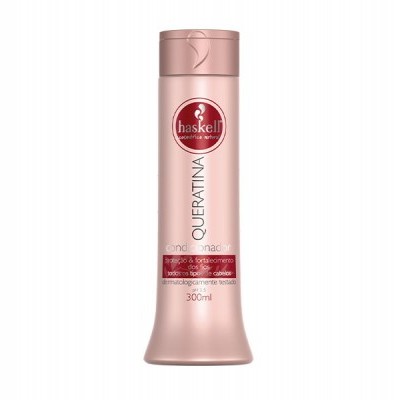 Frasco rosa claro do produto Haskell Queratina 300 ml com tampa, rótulo vermelho e branco