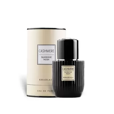 Frasco de perfume preto com embalagem cremosa cilíndrica