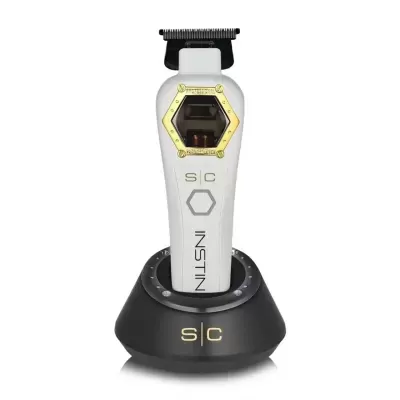 Máquina de cortar cabelo branca com detalhes dourados e base preta de carregamento