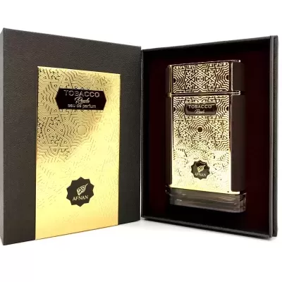 Frasco de perfume dourado e caixa preta com dourado e padrão abstrato