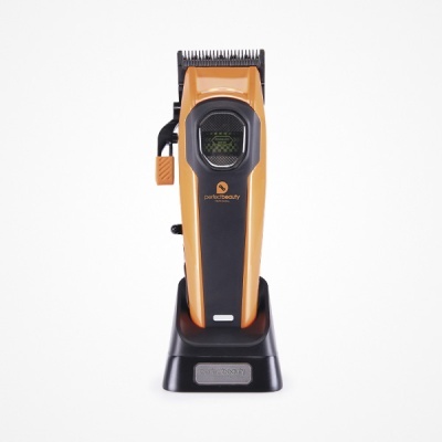 Aparelho de corte de cabelo laranja e preto com base de carregamento preta