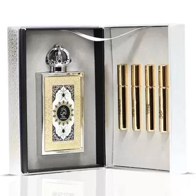 Conjunto de perfume com caixa aberta mostrando garrafa grande dourada e quatro frascos pequenos dourados