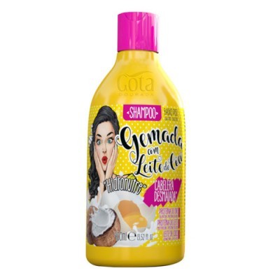 Frasco amarelo de shampoo Gota Dourada com tampa rosa e imagem de coco e mulher
