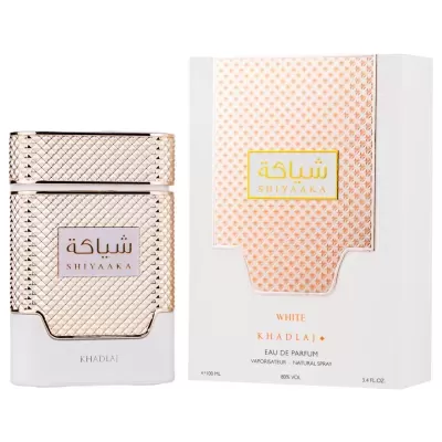 Frasco e caixa de perfume branco e dourado com padrão texturizado e texto SHIYAAKA KHADLAJ.