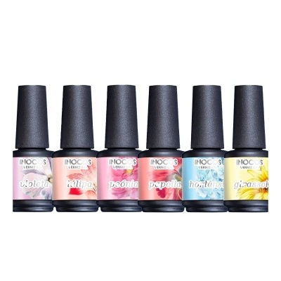 Seis frascos de verniz de unhas Inocos com diferentes cores e tampas pretas, dispostos em fila.