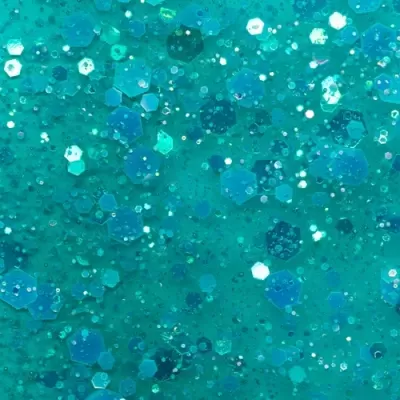 Textura cintilante azul e verde com partículas hexagonais e redondas