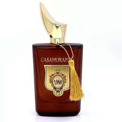 Frasco de perfume CASAMORANO 1988 com tampa dourada e tassel amarelo, vidro castanho