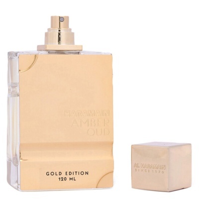 Frasco de perfume dourado e transparente com tampa dourada ao lado