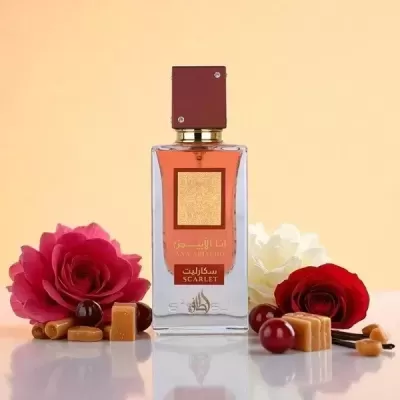 Frasco de perfume com flores vermelhas e brancas e caramelos