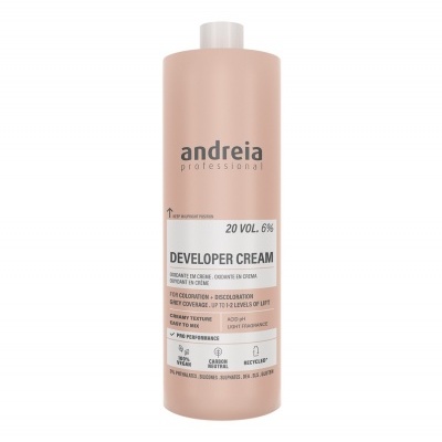 Frasco rosa claro de creme revelador andeia professional com texto informativo