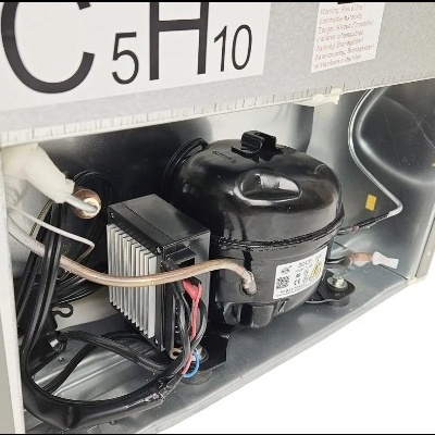 Interior de equipamento com compressor preto e tubos de cobre
