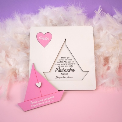 Cartão convite branco com estrela recortada e envelope rosa sobre penas brancas e fundo rosa