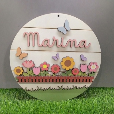 Placa redonda em madeira com nome Marina e flores coloridas