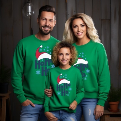 Família com sweatshirts verdes com estampa Ho Ho Ho e chapéu de Natal