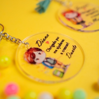Porta-chaves redondo transparente com ilustração de criança e texto em fundo amarelo