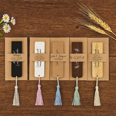 Marcadores de páginas variados com tassels coloridos e etiquetas personalizadas sobre mesa de madeira