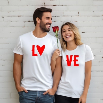 Casal com t-shirts brancas com texto vermelho L♥ e VE com rosa vermelha