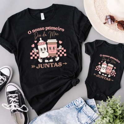 Camisola e body pretos com ilustração e texto O nosso primeiro Dia da Mãe Juntas, chapéu, óculos de sol, ténis e calças jeans sobre fundo cinzento.