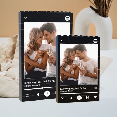 Moldes de blocos de construção pretos com interface de música e casal a brindar em imagem