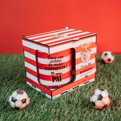 Caixa de madeira vermelha e branca com emblema do Benfica e bolas de futebol no chão
